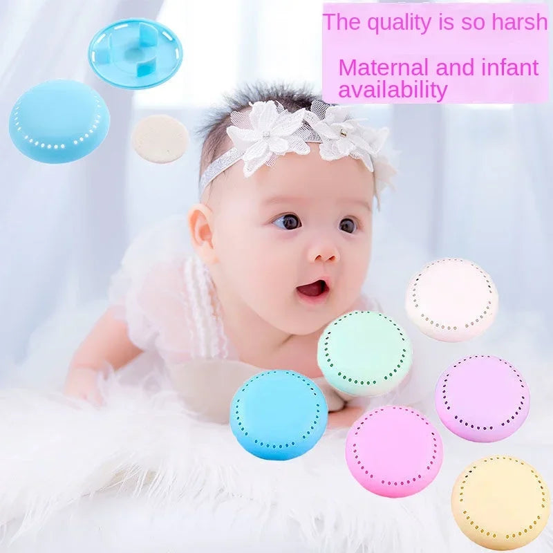 Baby playing with colorful home fragrance solid air fresheners on a soft blanket.