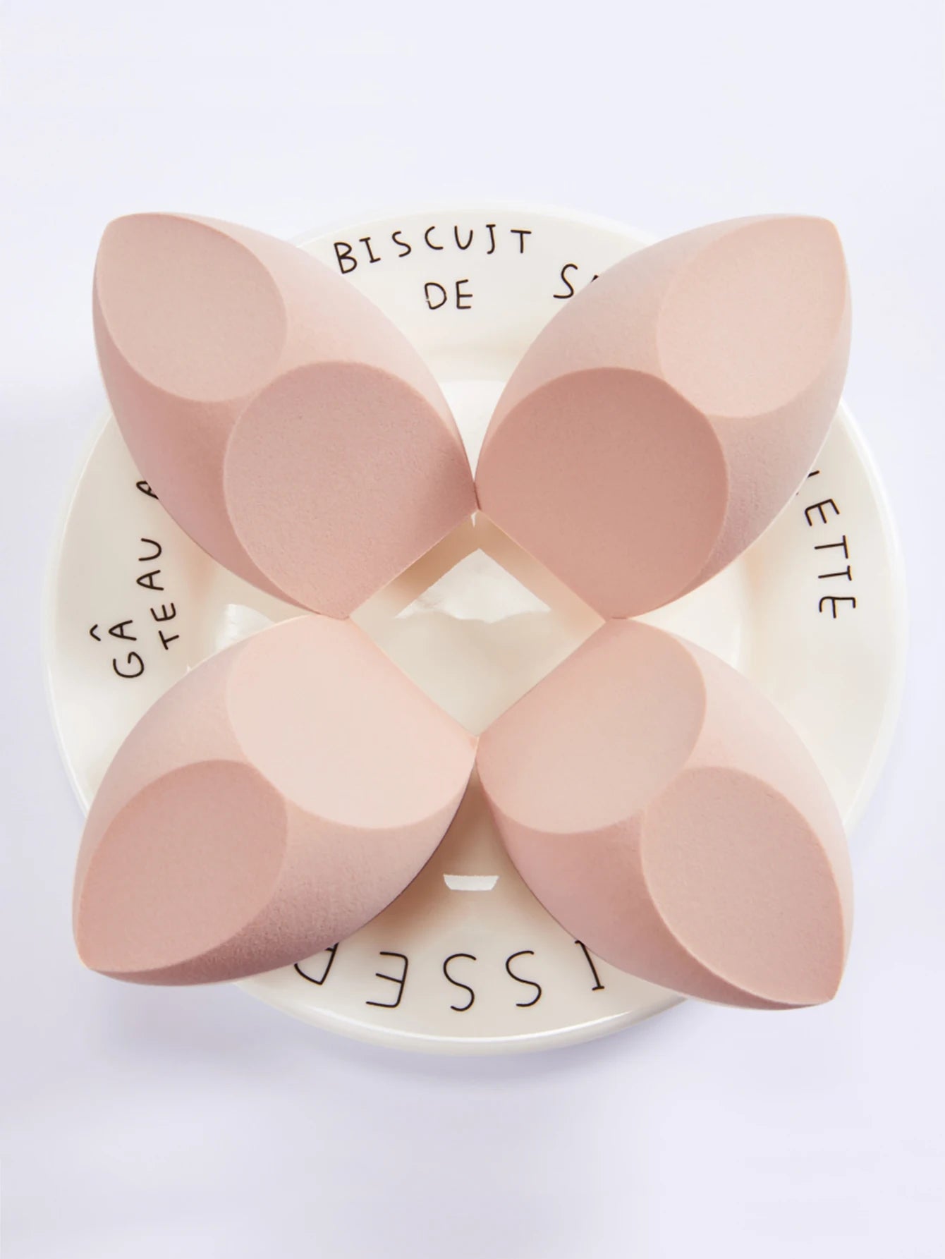 1 Pack Big Size Makeup Sponge Foundation Cosmetic on a decorative plate, showcasing its unique shape and design.