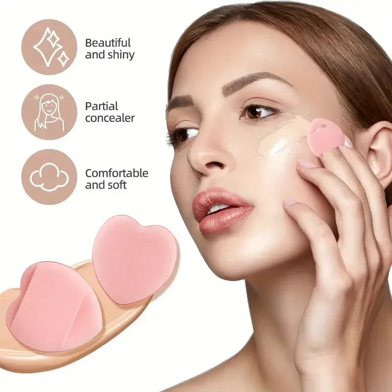 Woman applying foundation with a heart-shaped makeup sponge, showcasing a beautiful and shiny finish.