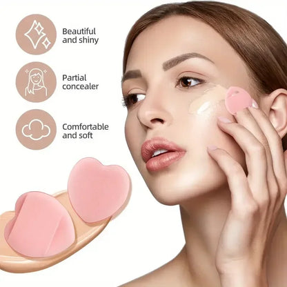 Woman applying foundation with a heart-shaped makeup sponge, showcasing a beautiful and shiny finish.