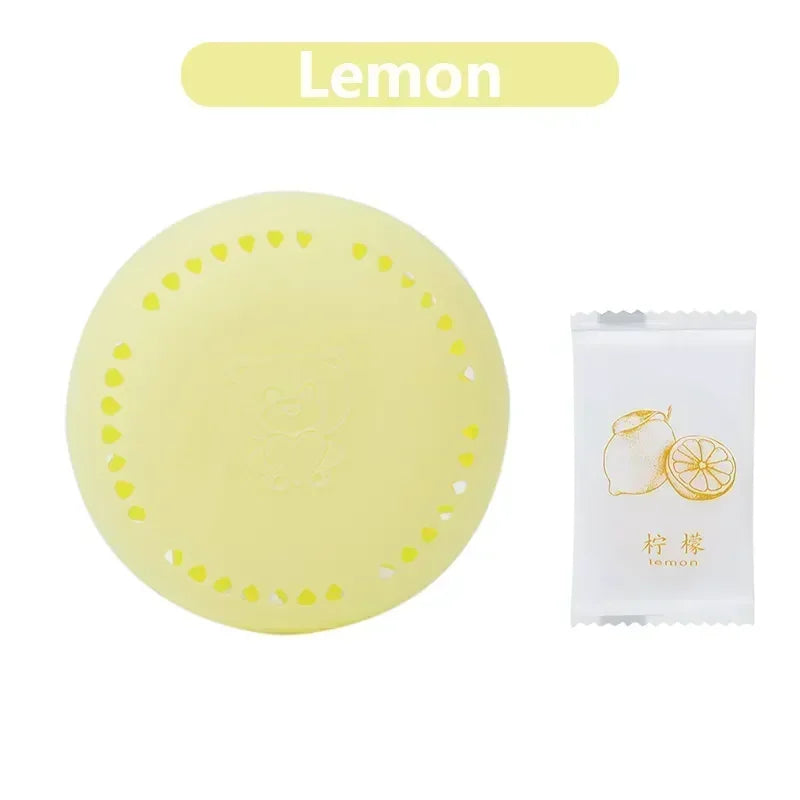 Home fragrance solid air freshener in lemon scent with a yellow circular design.