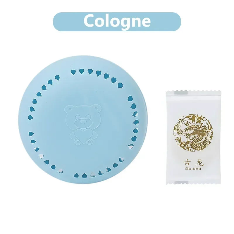 home fragrance solid air freshener in light blue with bear design next to a cologne sample
