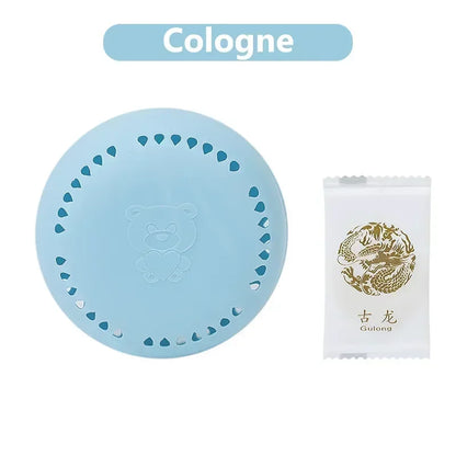 home fragrance solid air freshener in light blue with bear design next to a cologne sample