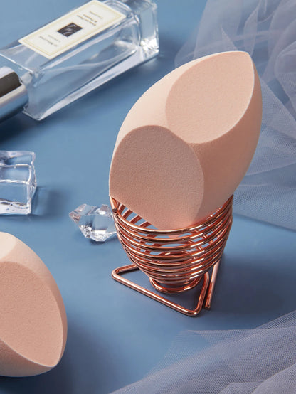 1 Pack Big Size Makeup Sponge Foundation Cosmetic displayed on a soft blue surface with ice cubes and a copper holder.