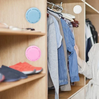 Home fragrance solid air freshener displayed in a modern closet with clothing and shoes.